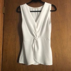 Sleeveless white twist front blouse